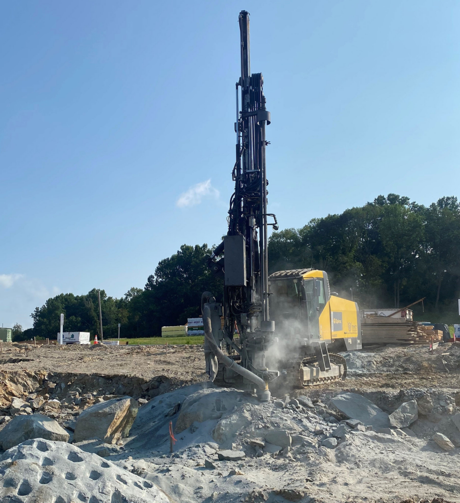 trinity-drilling-in-progress Large drill drilling into ground on sunny day